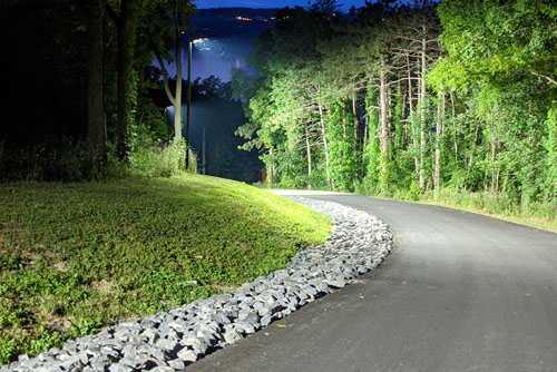 lit paved driveway at night